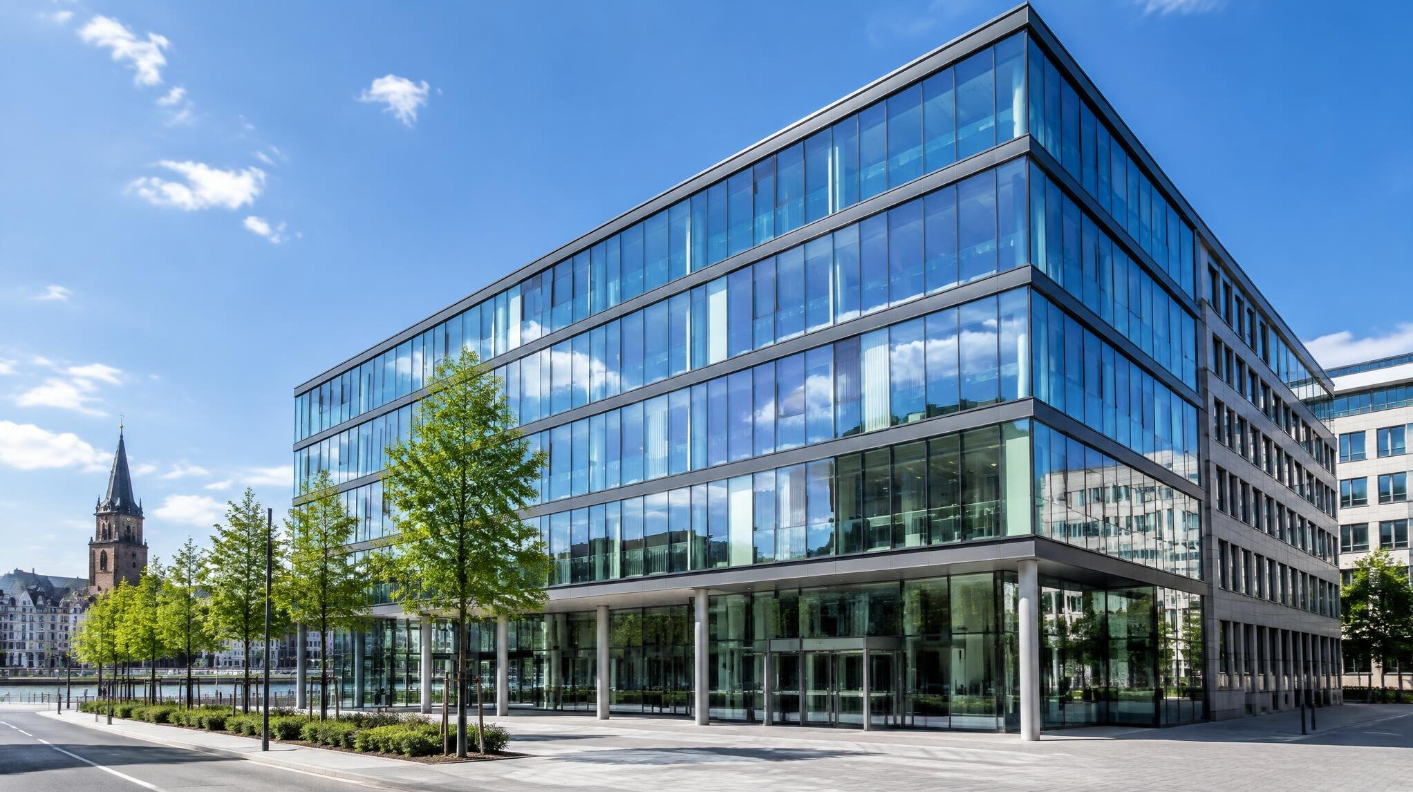 Modern glass-fronted office building facade in a German city